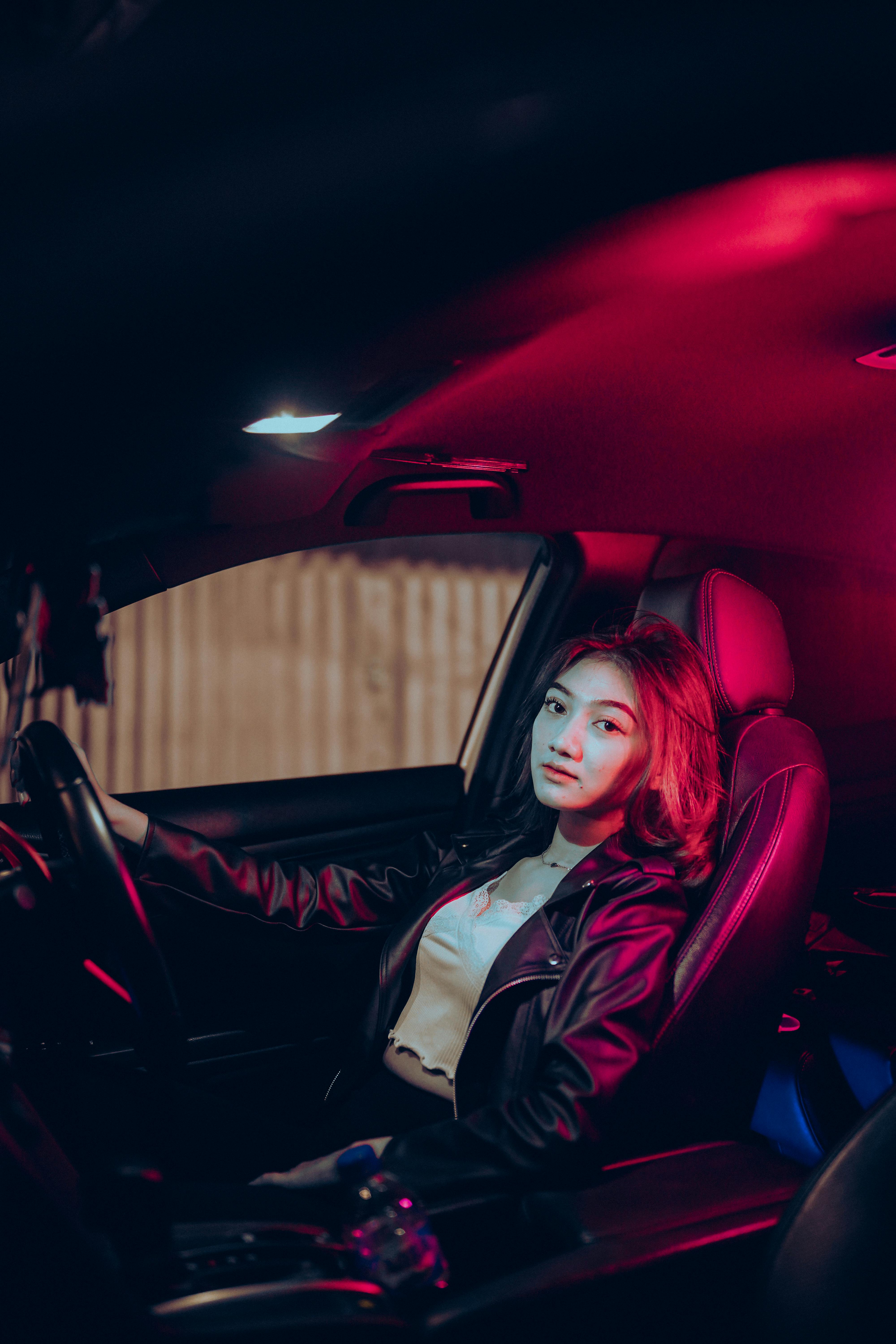 young woman sitting in modern car