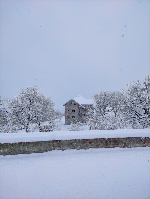 View of a House in the Countryside Covered in Snow 