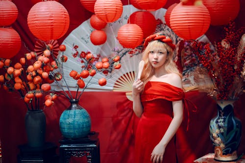 Young Woman in a Red Dress on the Background of Traditional Chinese Lanterns 