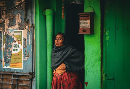 Woman Wearing a Shawl Standing in a Doorway