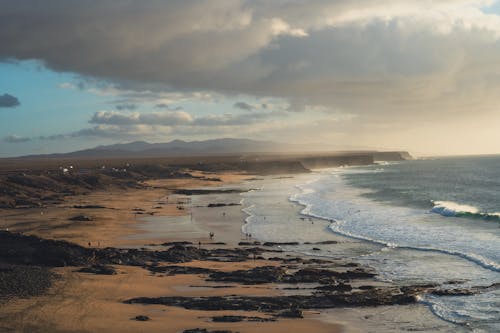 Cloudy Sky over People on a Sandy Beach