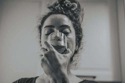 Monochrome Photograph of a Woman Drinking