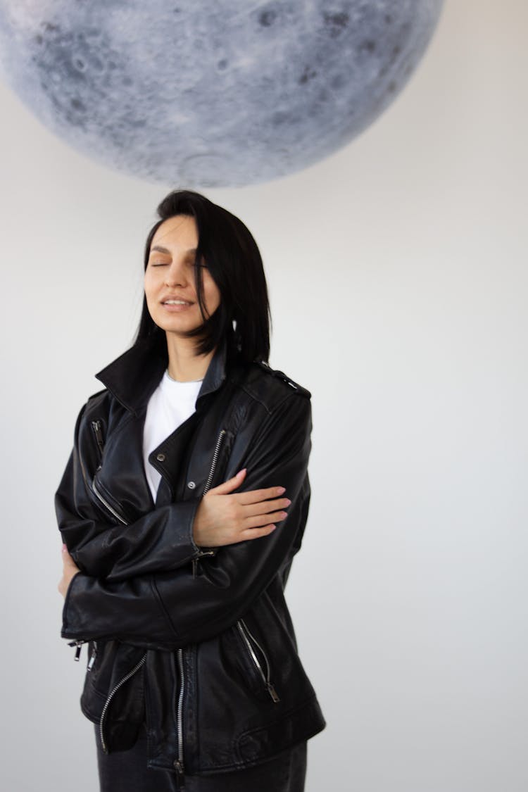 Smiling Woman With Eyes Closed Standing Under The Image Of The Moon