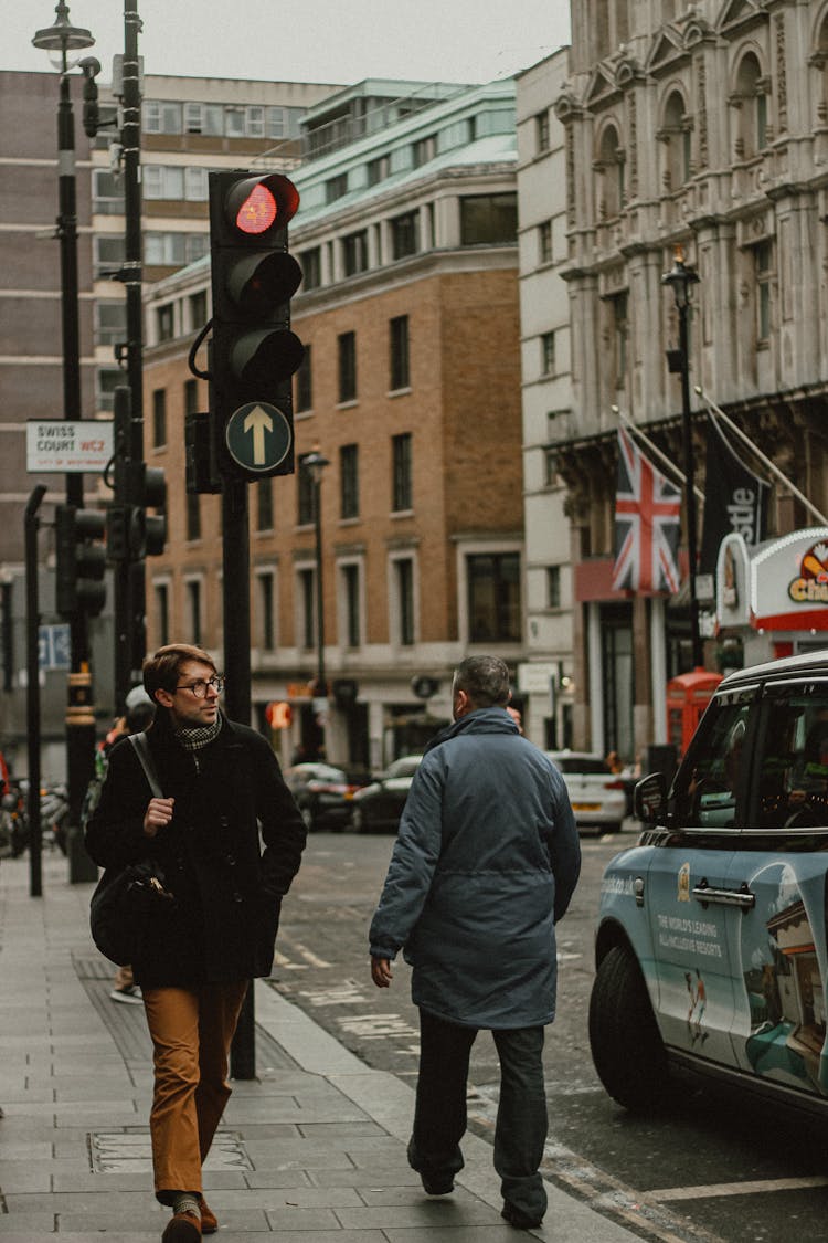 People Walking On The Street Near Traffic Light