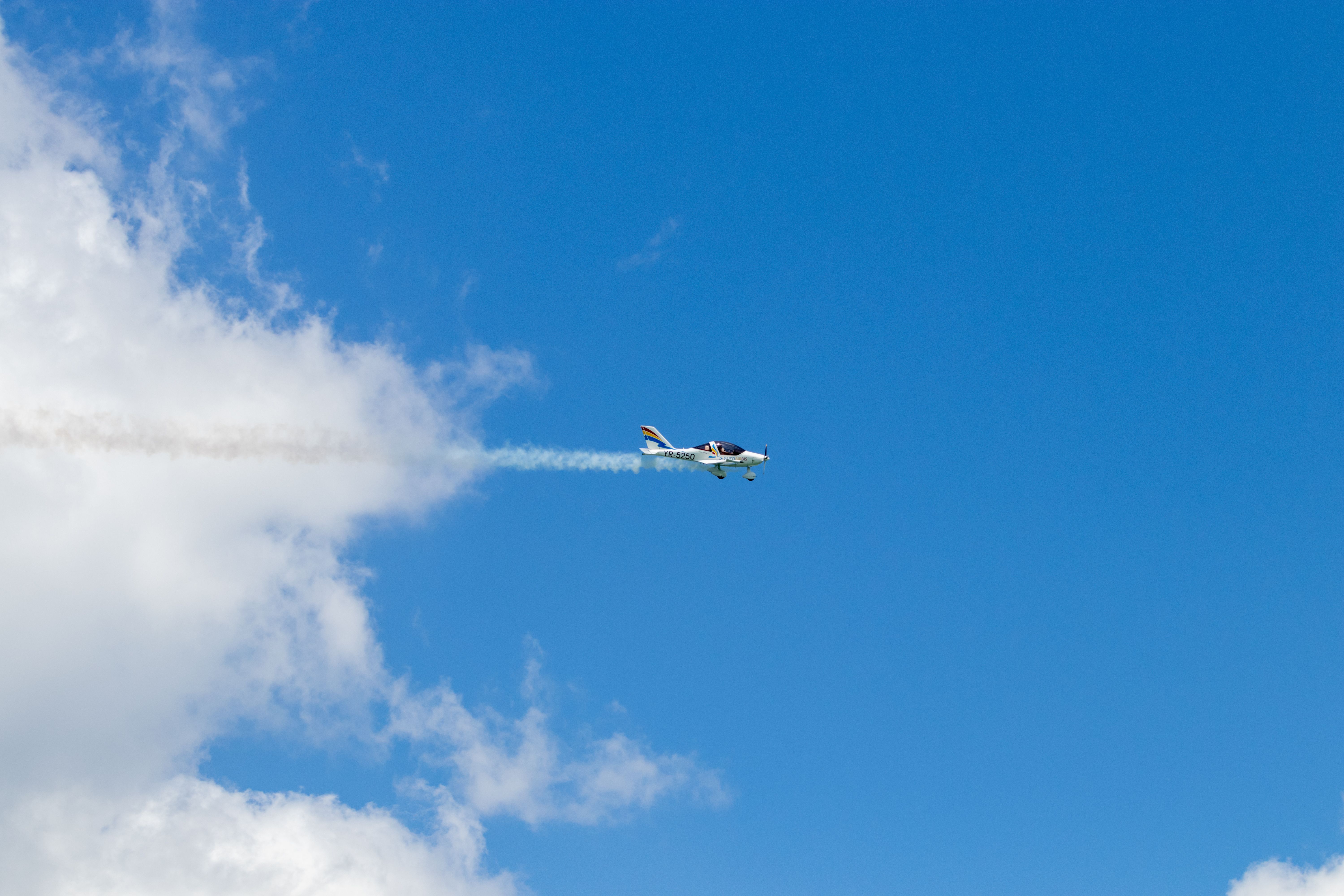 A Plane Flying Across the Blue Sky · Free Stock Photo