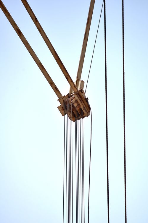 Free A detailed view of a crane pulley system with clear blue sky background in Fès, Morocco. Stock Photo