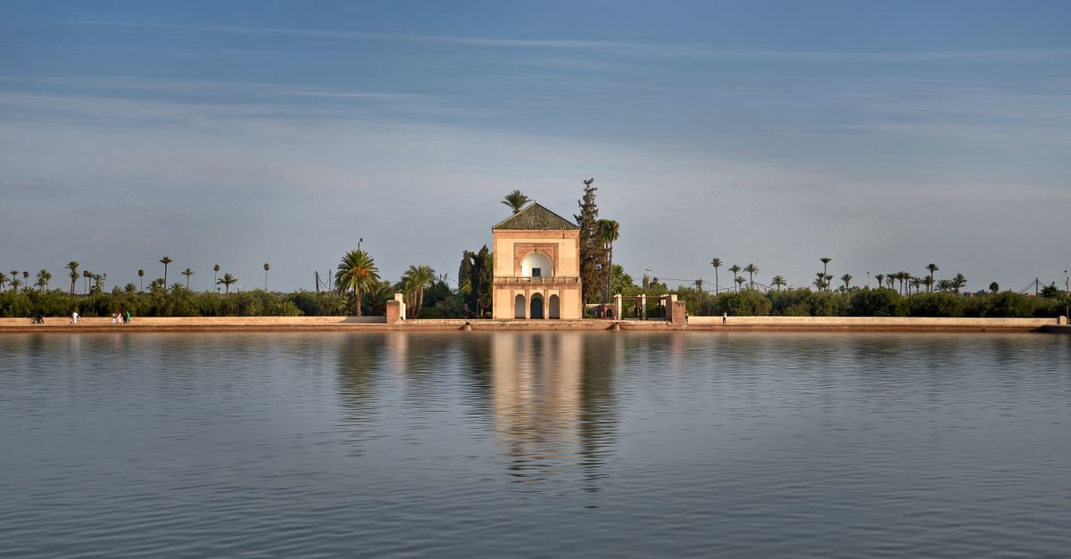 Menara Gardens pavilion reflected in water in Marrakech.