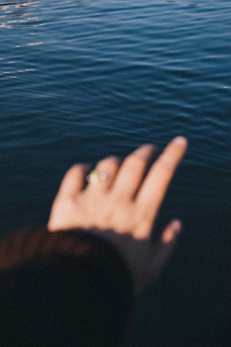 Woman Hand Reaching Into Sea