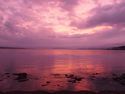 Free Gorgeous pink sunset reflecting over Matsue Lake, creating a dramatic sky. Stock Photo
