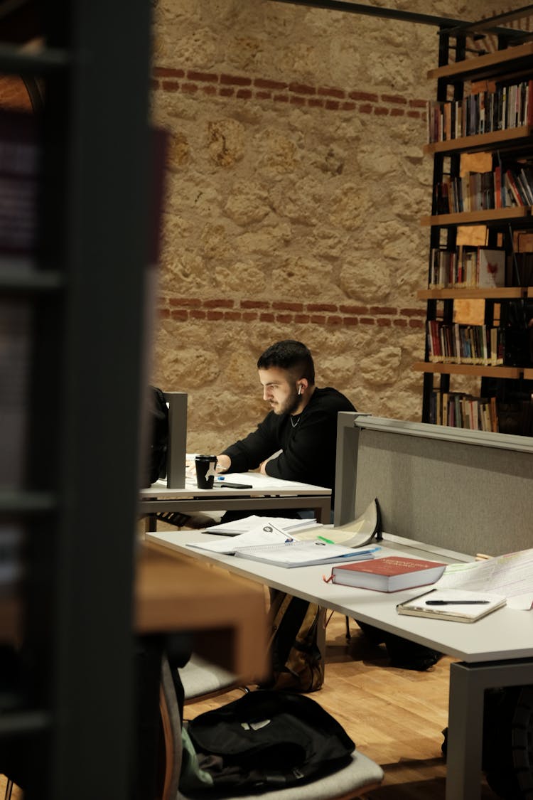 Man Sitting In Library