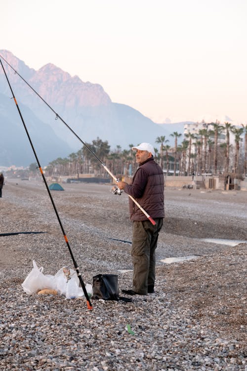 Man with Fishing Rods on Beach