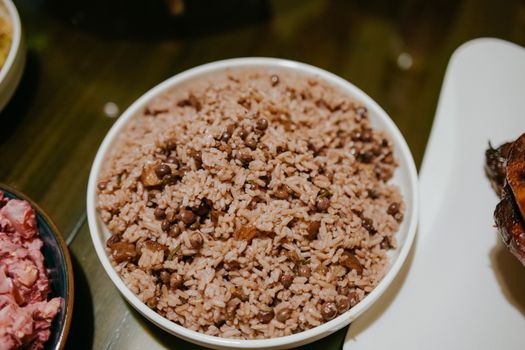 A close-up shot of a savory rice dish with beans served in a white bowl, perfect for food photography.