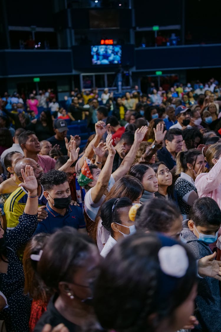 Audience Standing With Arms Raised