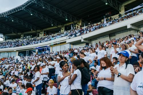 Free A vibrant crowd gathers in a stadium, enjoying an exciting event under a covered roof. Stock Photo