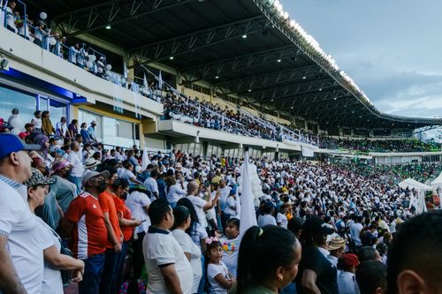 Free Large crowd of diverse sports fans enjoying a live event in an outdoor stadium. Stock Photo
