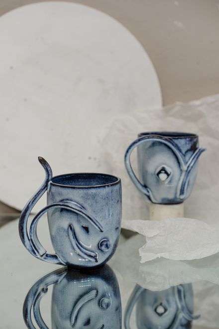 Handcrafted blue ceramic mugs with painted designs — photo by Galina Lasaeva on Pexels