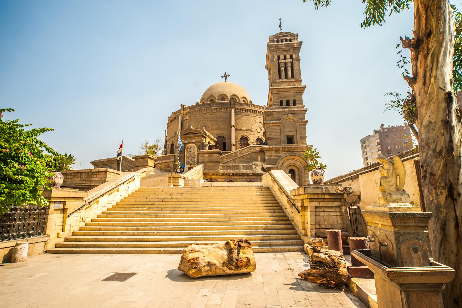 Exterior view of the historic St. George's Church in Cairo, showcasing its iconic tower and grand entrance stairs.