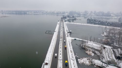 Free Aerial shot of a snow-covered bridge and road in Srinagar, Kashmir, during winter. Stock Photo