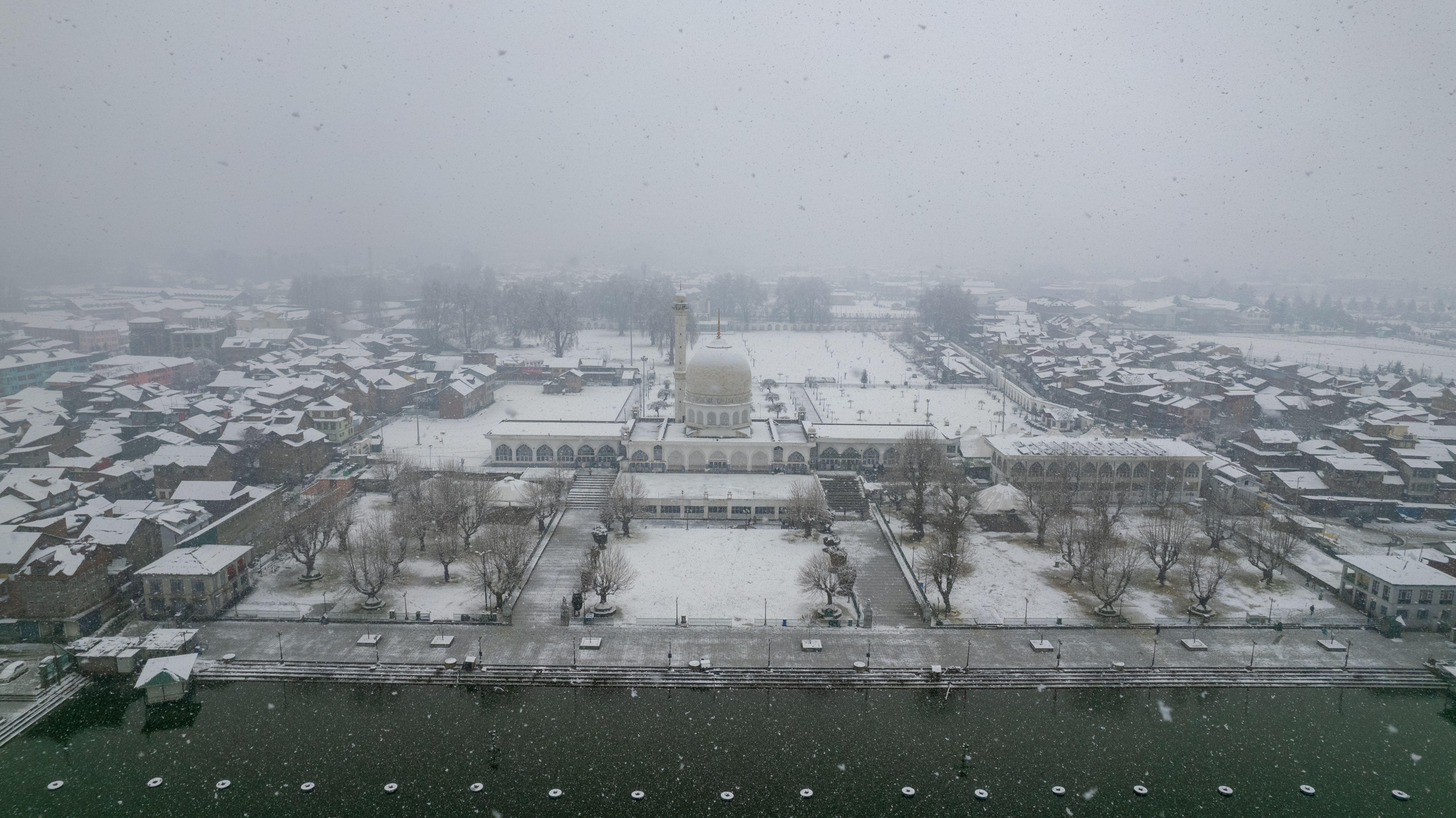 Aerial view of Hazratbal Mosque in Srinagar covered in snow during winter.