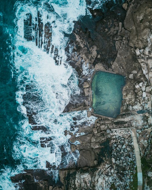 Natural Pool Beside Sea and Rock Formation Aerial Photography