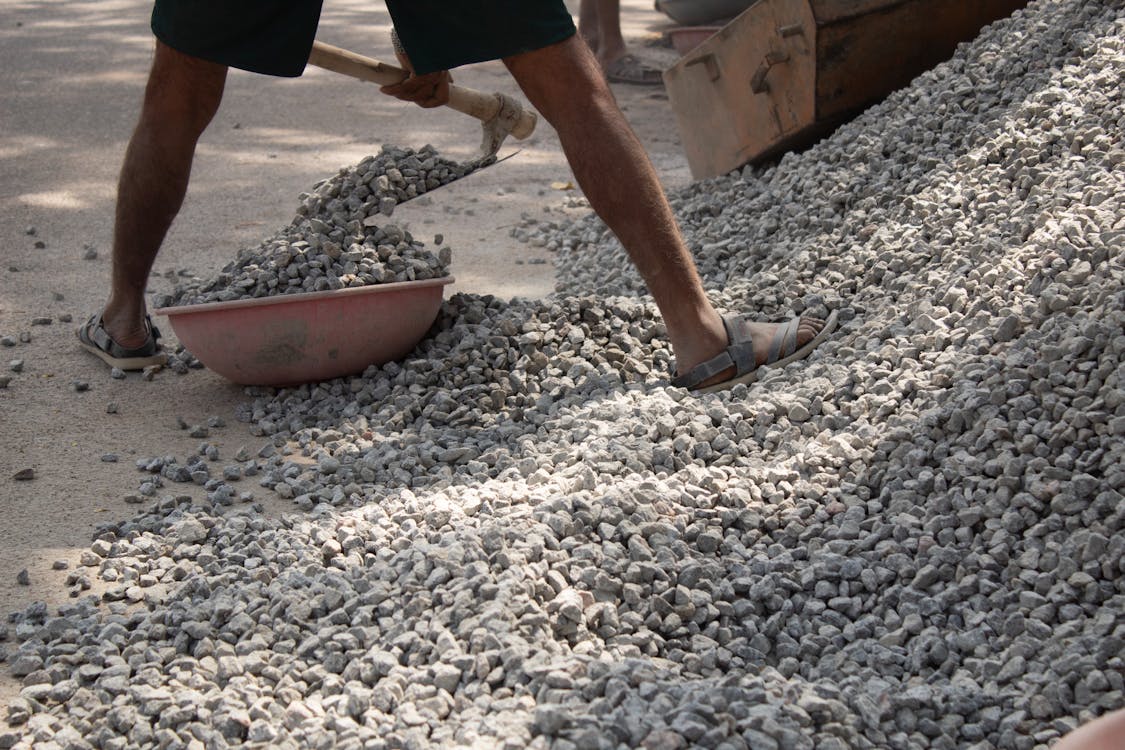 Man Collecting Stones on a Desert · Free Stock Photo