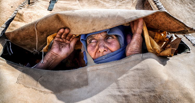 Woman Peeking Through Fabric