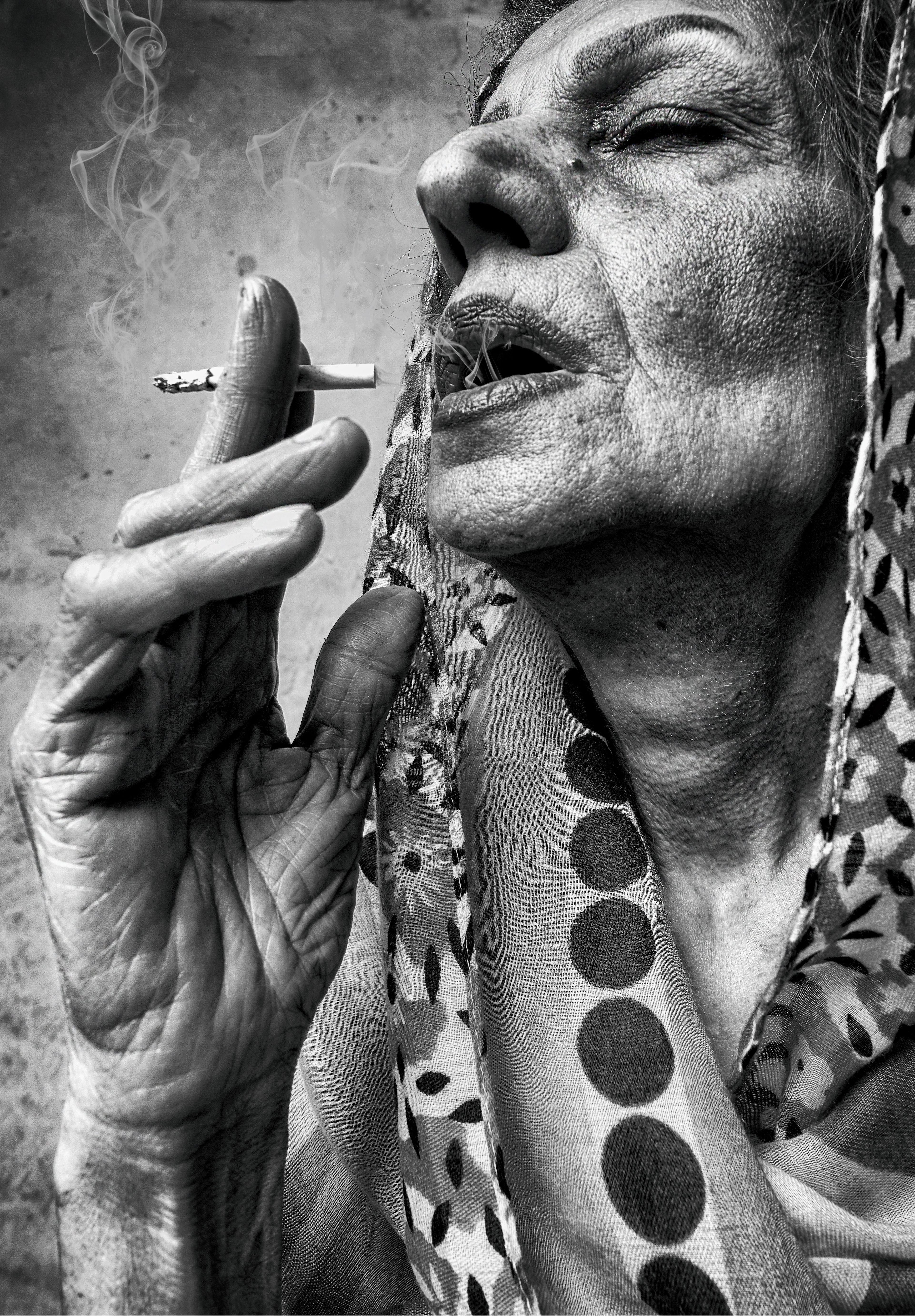 old woman smoking a cigarette Grayscale Photo of an Elderly Woman Smoking a Cigarette · Free Stock Photo