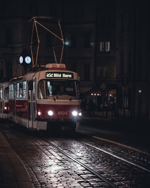 A Tram Crossing the Street at Night