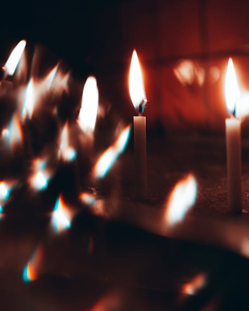 Wax Candles Burning in Darkness