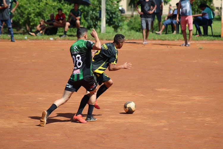 Two Men Playing Soccer 