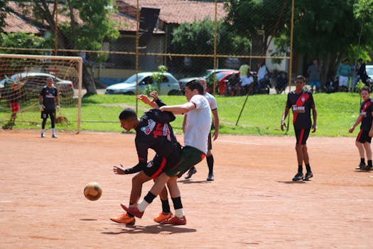 Players engage in a competitive soccer match on a sunny day at a local field.