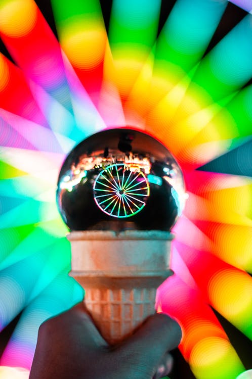 Person Holding Ice Cream Cone With Crystal Ball