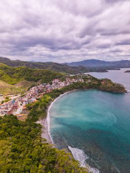 A stunning aerial view of a coastal town in Guanacaste Province, Costa Rica, featuring vibrant landscapes and tranquil waters.