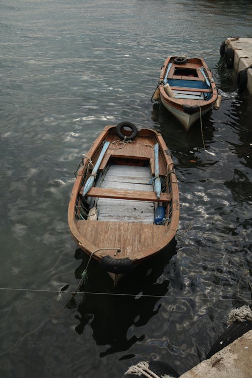 Empty Rowboats on River