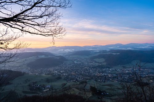 Valley town seen from the hills at dusk — photo by Thomas P on Pexels