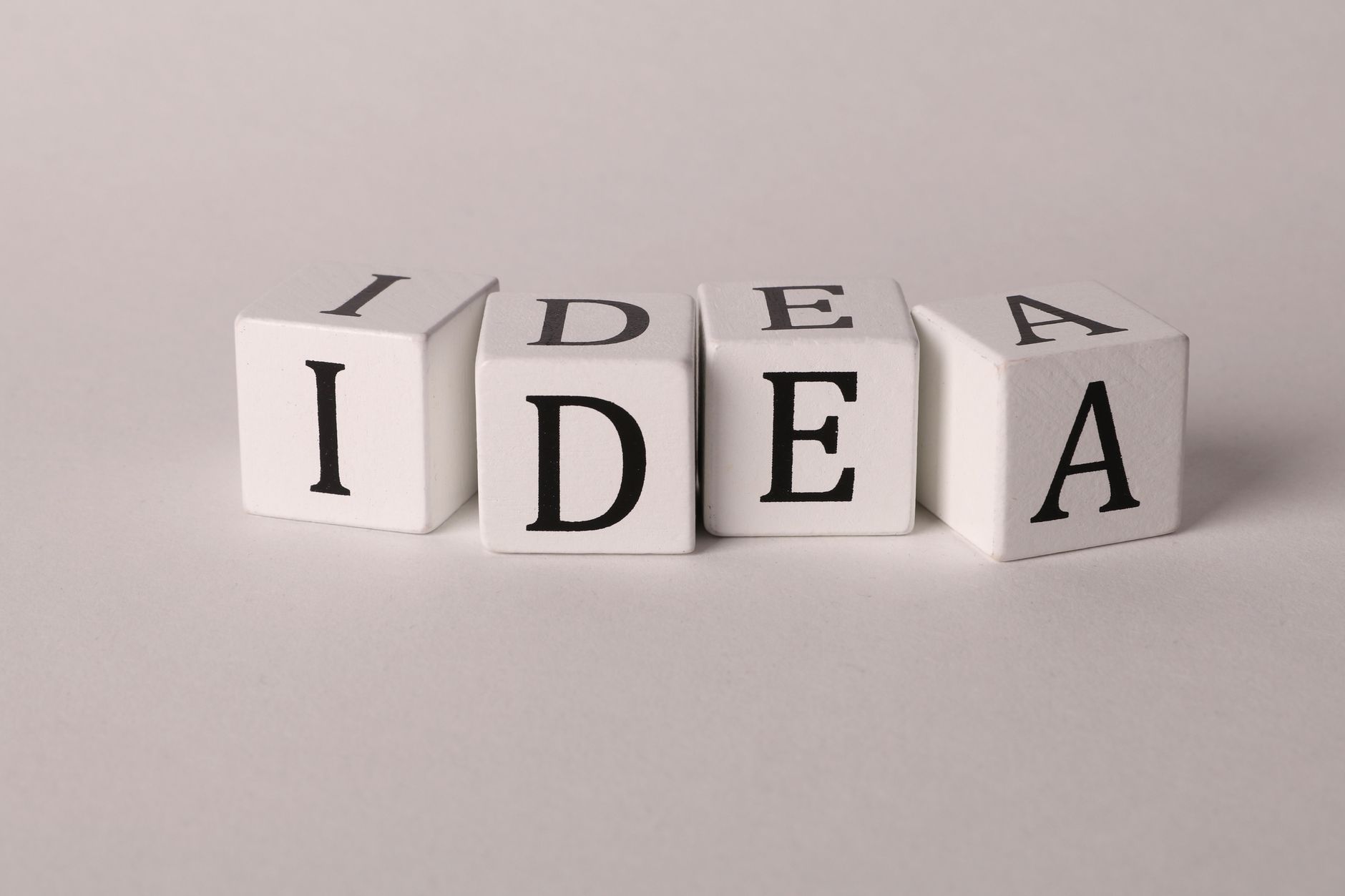 White blocks with letters spelling 'IDEA' representing creativity and innovation.