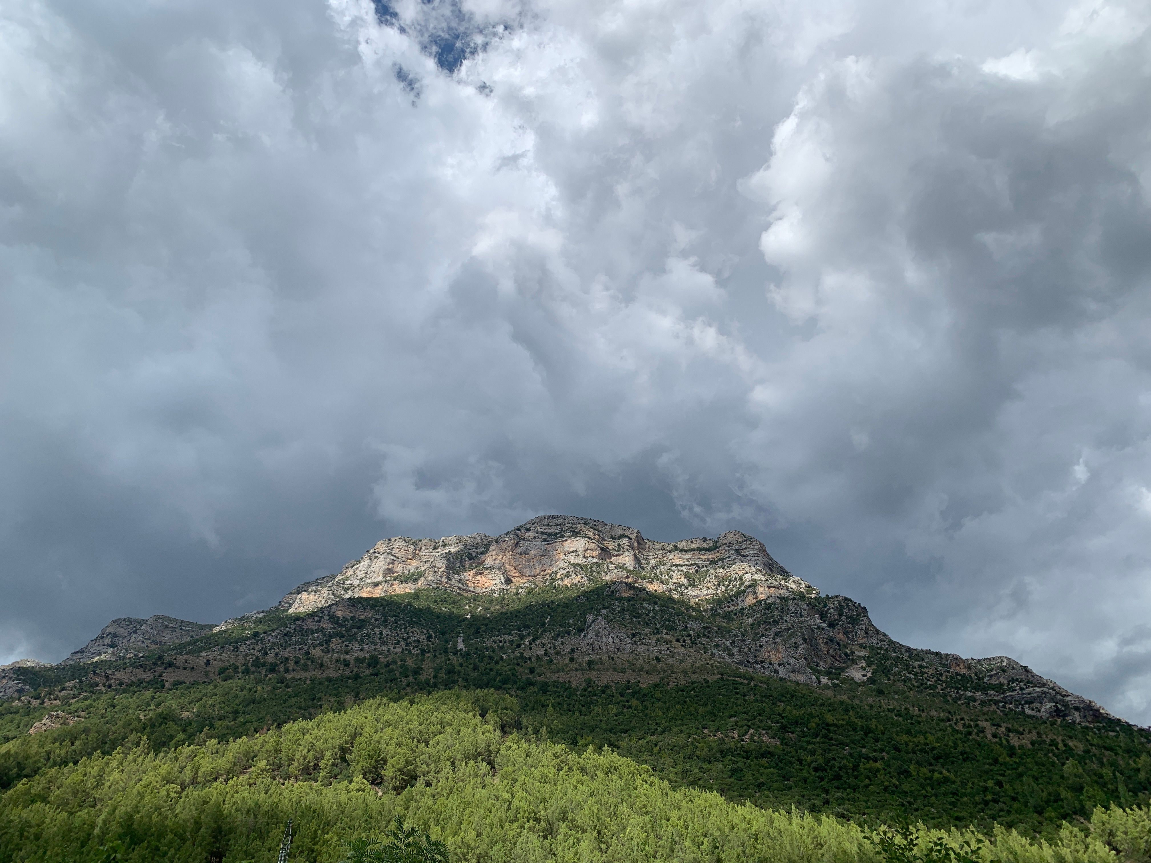 A Rocky Mountain under a Cloudy Sky · Free Stock Photo