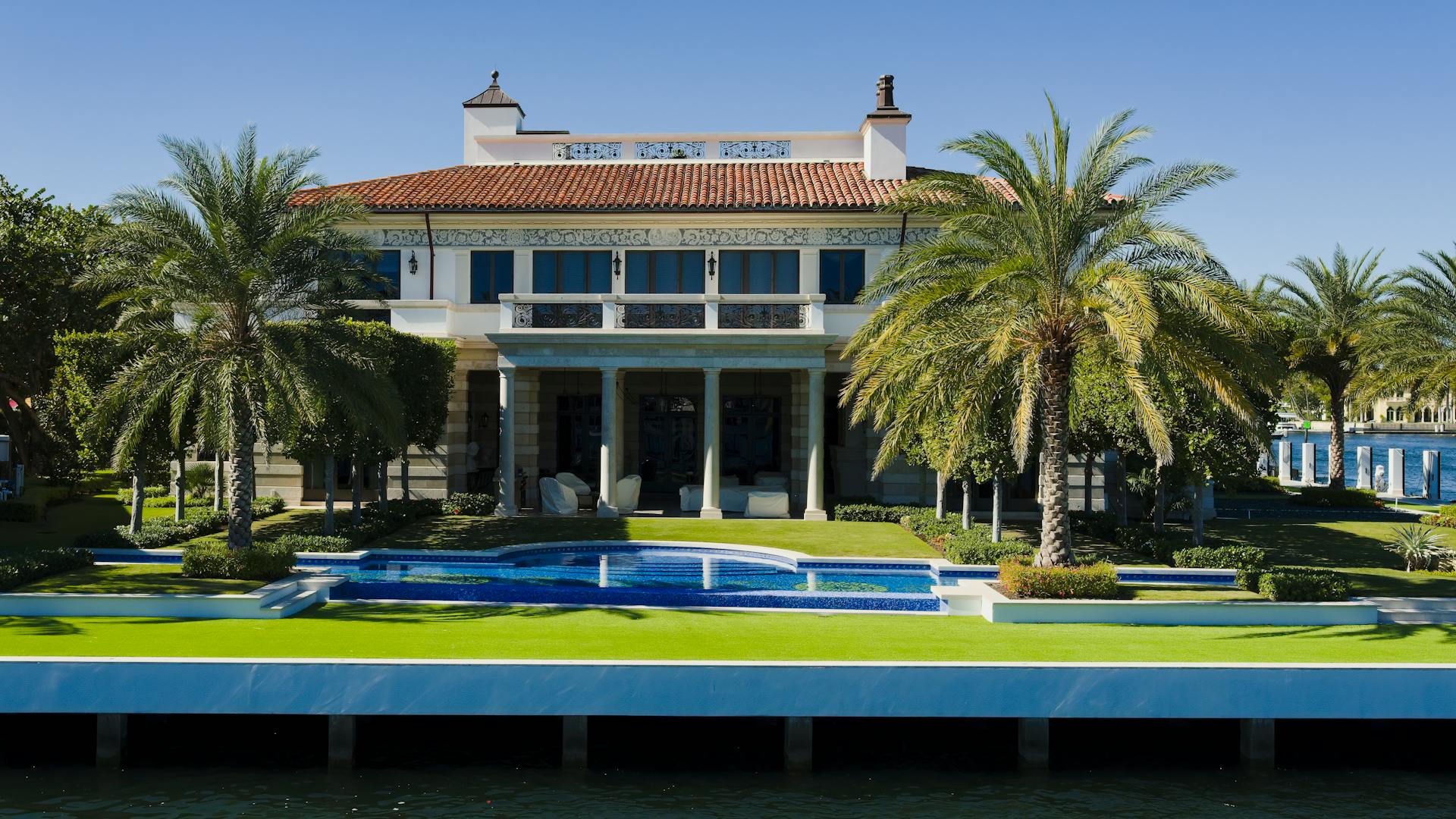 Elegant tropical villa in Fort Lauderdale featuring a lush garden and pool.