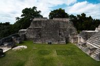 Explore the ancient Mayan pyramid surrounded by lush jungle and stone steps in Guatemala.