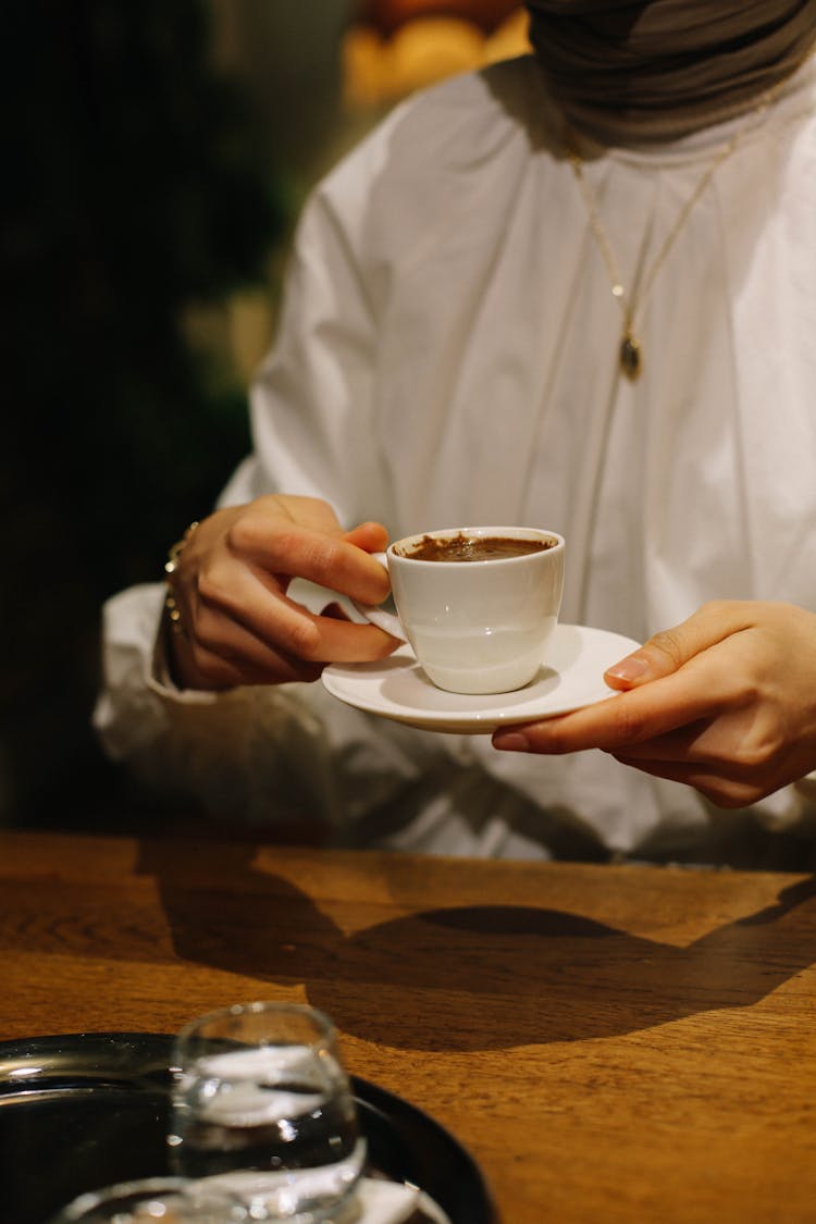 Hands Of A Person Enjoying A Cup Of Coffee