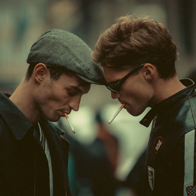 Men Smoking Cigarettes On City Street