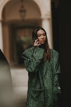 Fashionable woman in Milan talks on her phone, showcasing urban chic style.