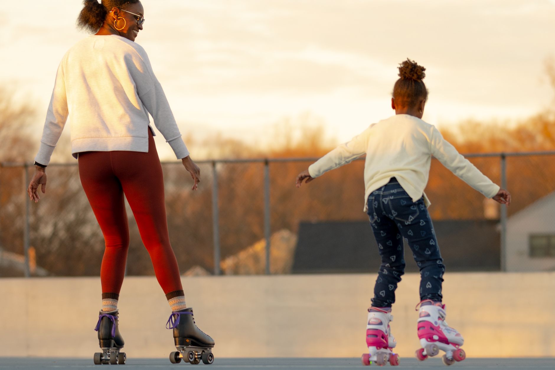 A mother and daughter enjoy roller skating together