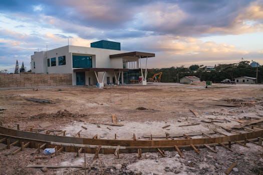 Contemporary building construction site in Spanish Lookout, Belize, during a cloudy day.