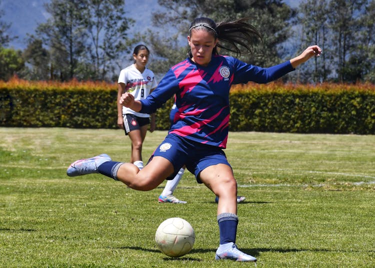 Football Player Kicking Ball