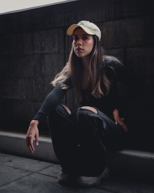 Free Stylish portrait of a woman with long hair wearing a cap in urban Ciudad de México setting. Stock Photo
