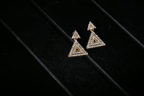 Earrings on Black Textured Surface 