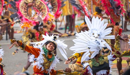 Free Colorful festival parade showcasing dancers in traditional costumes with feathers. Stock Photo