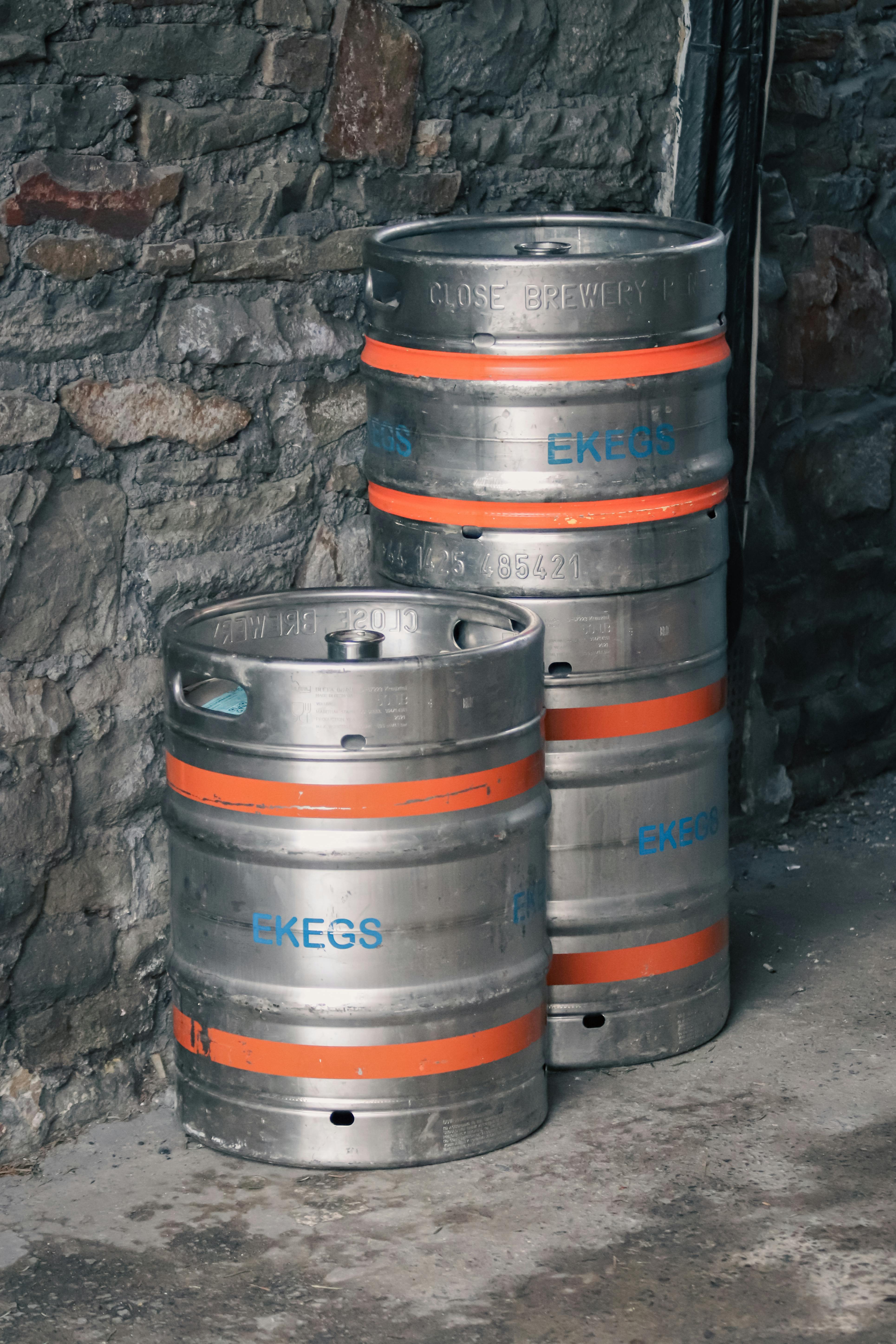 Beer Kegs Near Wall · Free Stock Photo