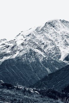 A breathtaking snowy mountain with rugged terrain under a clear winter sky.